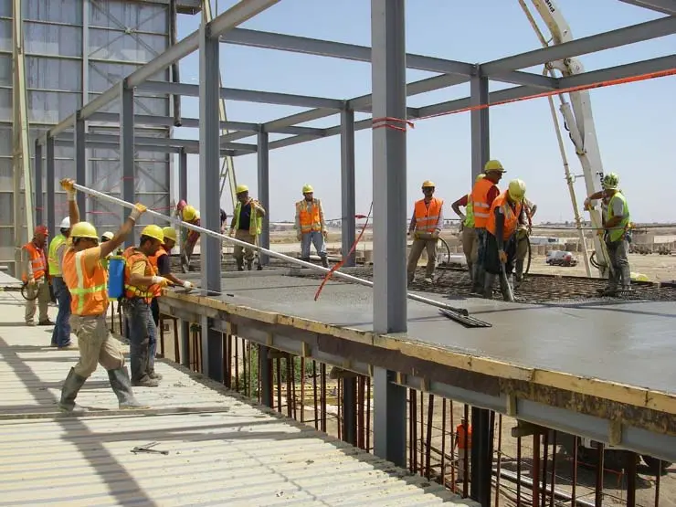 Construction team working on a reinforced concrete and steel structure